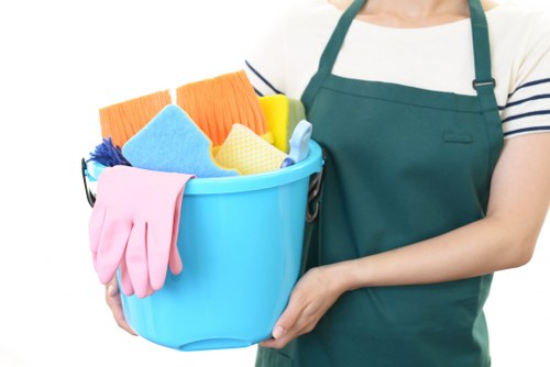 Cleaner in protective gear preparing a safe cleaning task in Ruislip