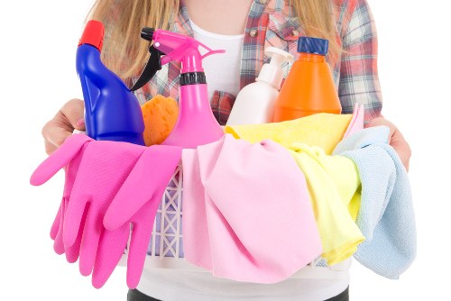 Professional cleaner tidying a kitchen in Ruislip